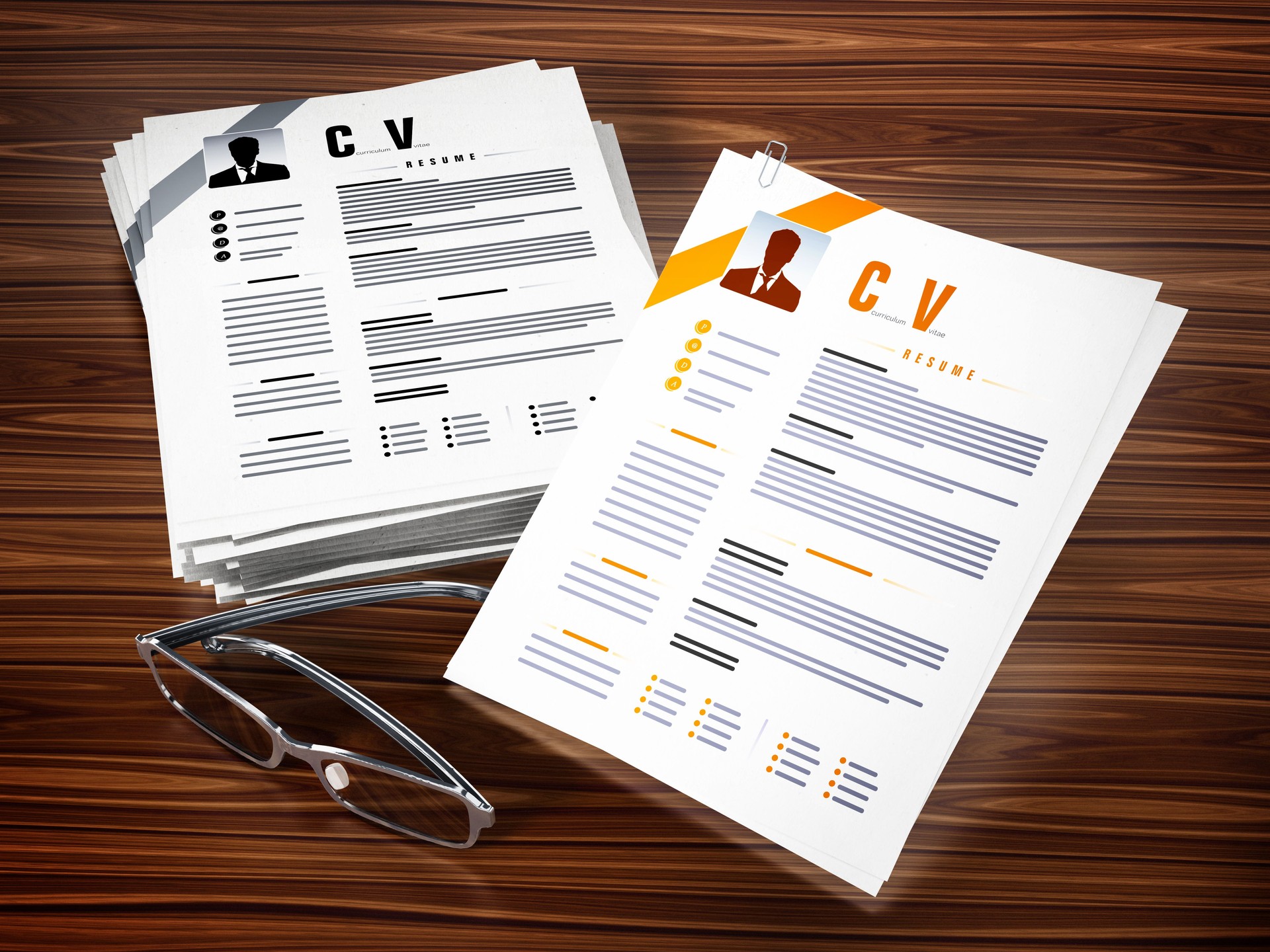 Generic resumes (CV) and glasses standing on wooden table